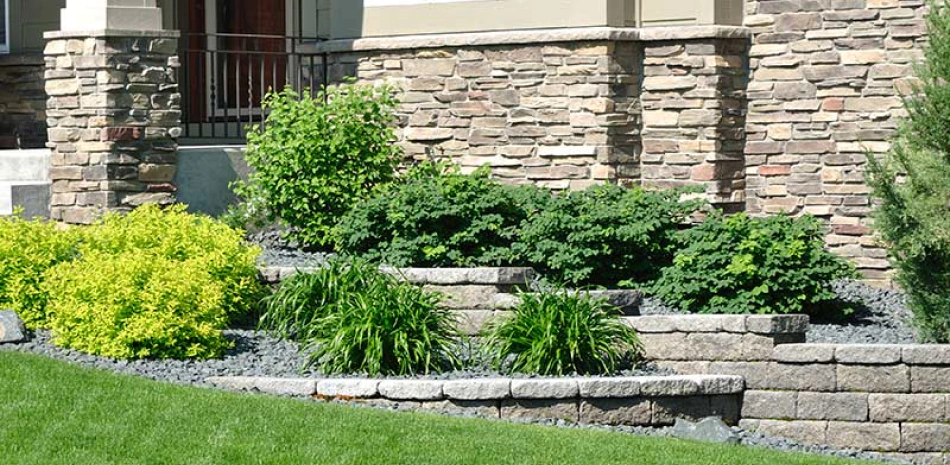 retaining walls of a landscape of a house with some bushes around
